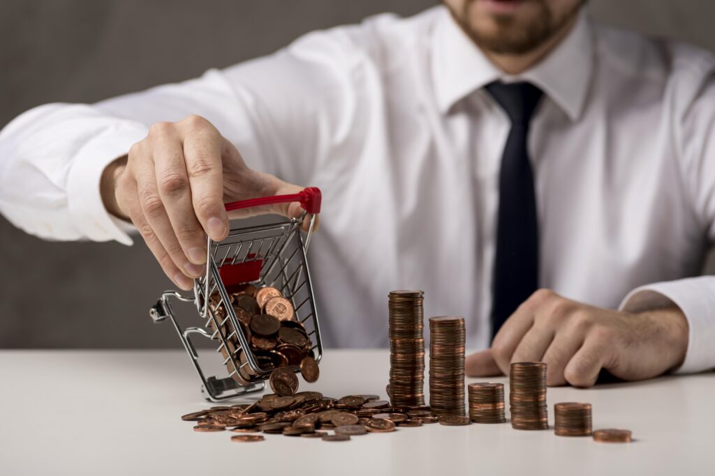 front view businessman spilling shopping cart coins
